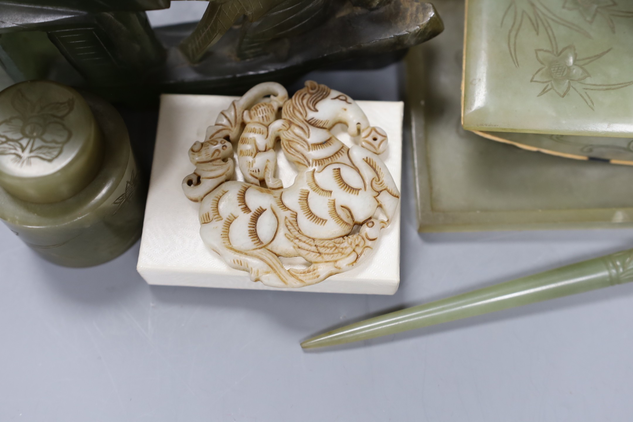 A Chinese bowenite jade desk set (7) and a plaque, model of junk 16cms high